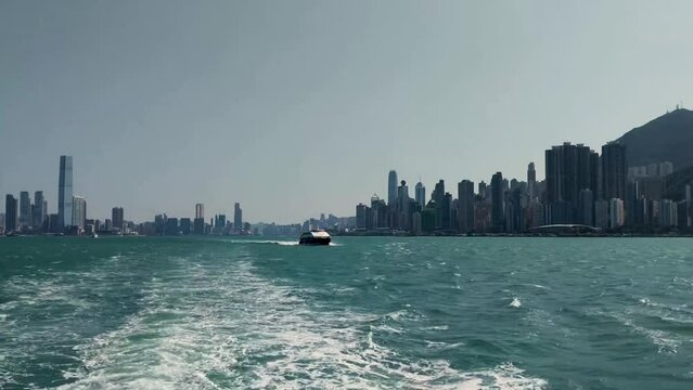 Victoria Harbor in Hong Kong, skyscraper buildings during the day, view from boat