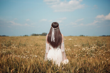Lone maiden in a summer wheat field - 571860863