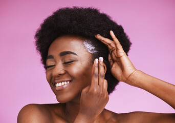Happy black woman, afro hair and conditioner treatment for ethnic texture on pink studio...