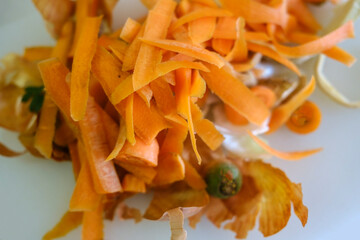 scraps from peeling organic carrots on a white board