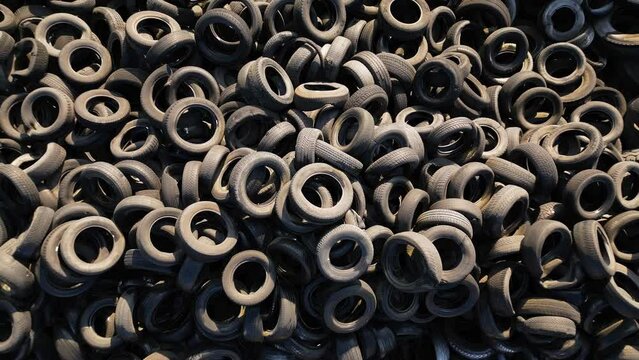 Aerial view of old tires dump. Many car and truck tires on dump site from above