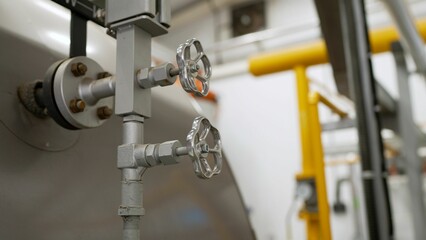 Faucet for water supply in a modern boiler room. Heating circulation pumps in commercial buildings,...