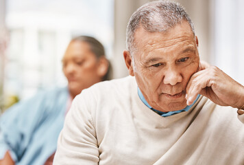 Obraz premium Stress, sad and divorce with old couple on sofa for breakup, discussion and frustrated. Fight, mental health and crisis with elderly man and woman in living room at home for toxic, conflict and fail