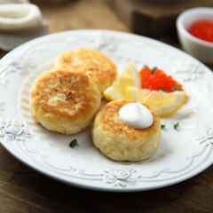 Homemade potato cakes with red caviar and lemon