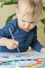 Cute little Girl painting picture on home interior background. Cute Little toddler girl drawing