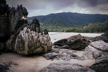 Beautiful Beach view with clouds, rocks and in the jungle 