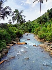 Panoramic landscape of bright blue river of dua rasa river and tropical rain forest