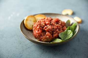 Homemade steak tartare with baguette bread