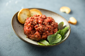 Homemade steak tartare with baguette bread