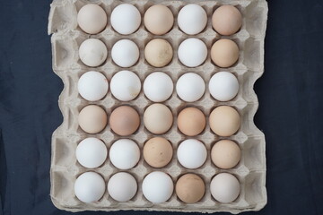 Eggs top view. Packing of fresh chicken eggs on marble background. 30 pieces