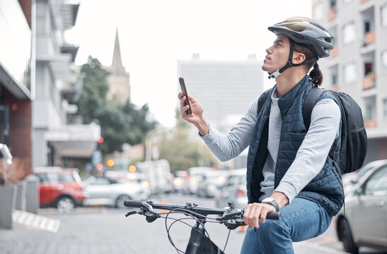 Travel, bike delivery or man with phone in London city, street or road for GPS, location or networking outdoor. Internet, search or male with smartphone for mobile app communication or 5g network
