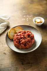 Homemade steak tartare with baguette bread