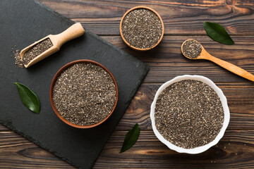 Chia seeds in bowl and spoon on colored background. Healthy Salvia hispanica in small bowl. Healthy superfood