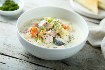 Traditional fish soup with vegetables and cream