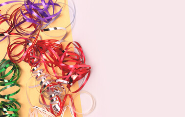 Multicolored ribbons on a gray background. Festive concept with copy space. Selective focus.
