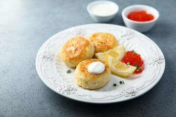 Homemade potato cakes with red caviar and lemon