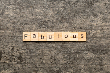 Fabulous word written on wood block. Fabulous text on cement table for your desing, concept