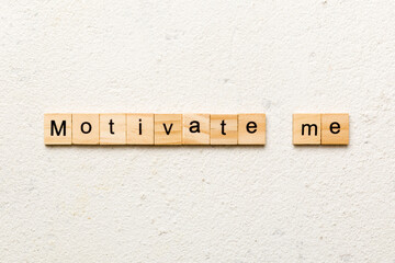Motivate me word written on wood block. Motivate me text on cement table for your desing, concept