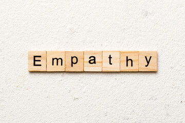 empathy word written on wood block. empathy text on table, concept - obrazy, fototapety, plakaty