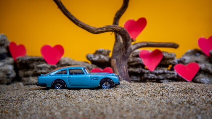 Minahasa, Indonesia : December 2022, toy car with gradient orange background and a heart