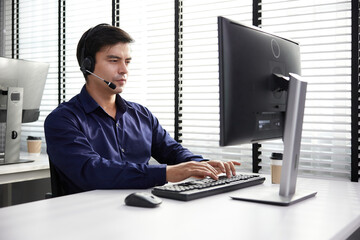 operator wearing headphones and talking online with customer at call center service