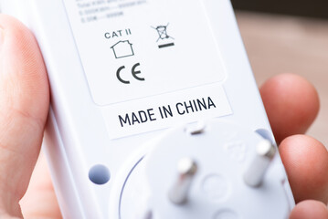 Close up shot of socket computer timer with inscription Made in China. Concept of production of...