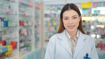 Smiling face of young professional asian woman pharmacist close up looking at camera in drugstore