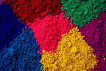 Fototapeta na wymiar Bright colored background of various powder paints: pink, yellow, blue, green
