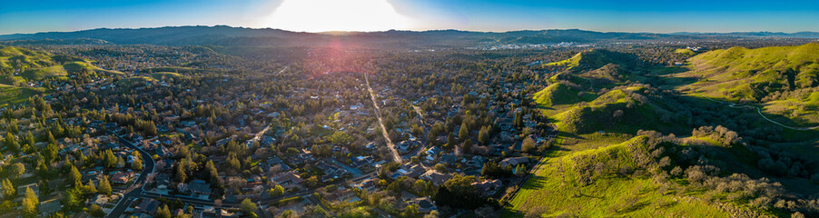 Wallnut Creek Aerial Panorama. Suburban city and green hills at sunset
