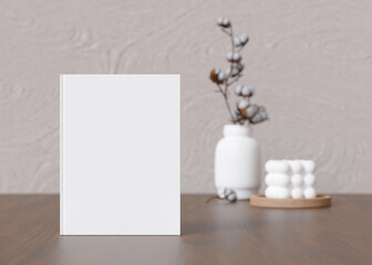 White book cover mock up with vase and candle on sideboard. Blank template for your design. Front view, close-up. Book, catalogue cover presentation. 3D rendering.