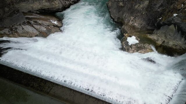 the lech fall near f&uuml;ssen in bavaria in the alps where a lot of water flows into the valley and the water flows back and forth between the rock walls recorded with a drone