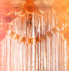 Birthday party decor. Foil curtains and bauble. Cozy home interior decoration for celebration.