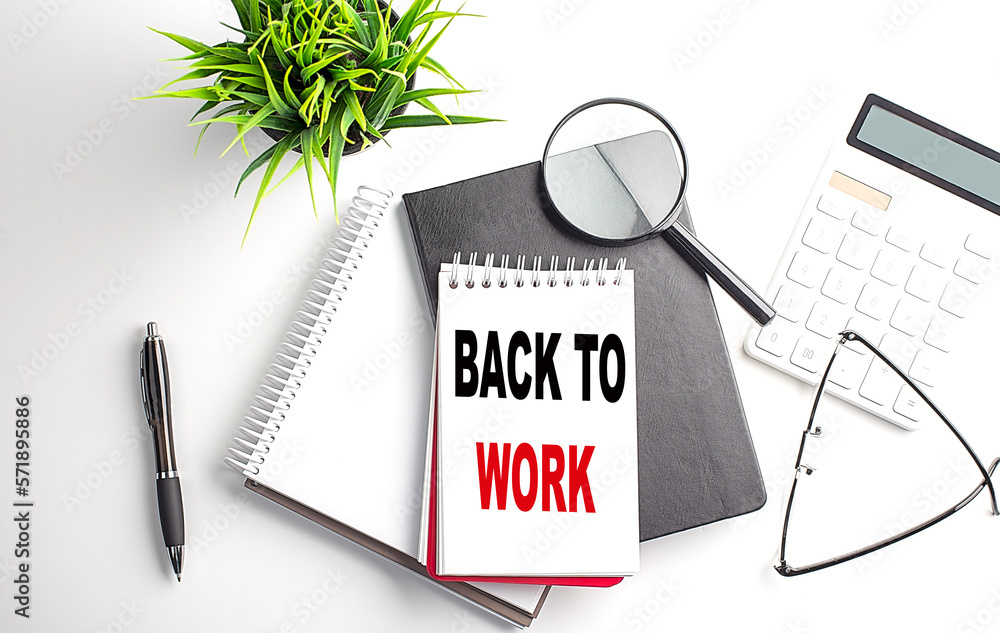 Poster text back to work on notebook with office tools on white background
