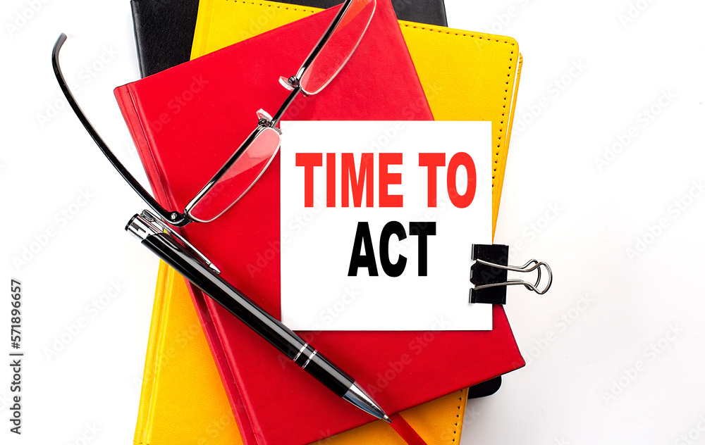 Poster time to act text written on a sticky on colorful notebooks