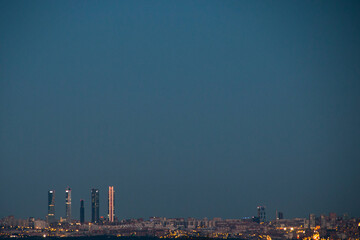 The four towers of Madrid, actually five, at night. You can see the skyline of the city