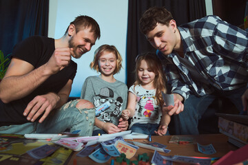 Staged photo. Homosexual couple and their children, two cute girls, at home. 