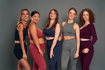 Portrait of five young women in sports clothes in studio shot
