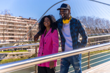 Young african american women in the city, friends lifestyle, walking on vacation laughing