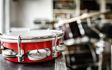Red tambourine in recording studio for live perfomance. Professional musical instrument for ethnic concerts