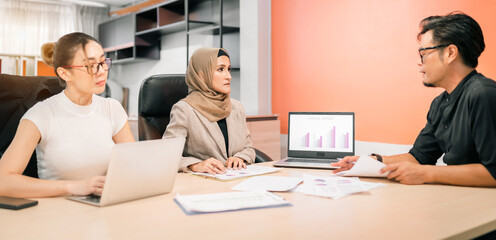 business muslim and asian woman and man have meeting. international convention room with group of diversity people having a conversation in workplace. adult worker present showing benefit for company