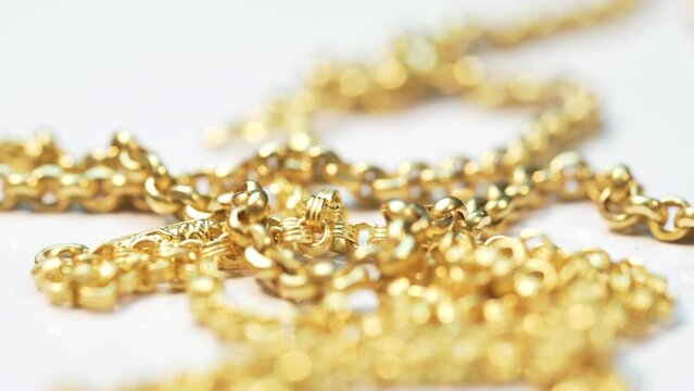 Closeup shot of gold necklaces with rotating
