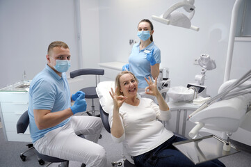 dental office satisfied patient showing thumbs up big class liked service new technologies masked...