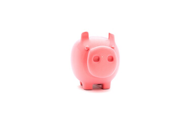 Shiny pink piggy bank on brightly lit white background. Savings and personal finance concept.