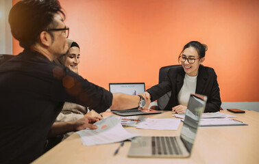 business muslim and asian woman and man have meeting. office woman explain project plan in future for organization and worker to work. talking team sitting in conference room to debate about company