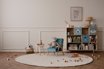 Minimalist composition of kid room interior with copy space, mock up poster frame, blue armchair, wooden sideboard, beige rug plush toys, wooden blockers and personal accessories. Home decor. Template