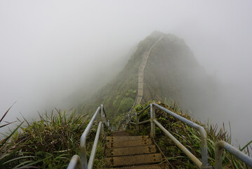 Haiku Stairs to heaven in clouds.  Known as Stairs to Heaven or Haiku Ladder. Steel step Structure  provide pedestrian access to CCL Bunker at the top of Koolau mountain in Oahu island in Hawaii