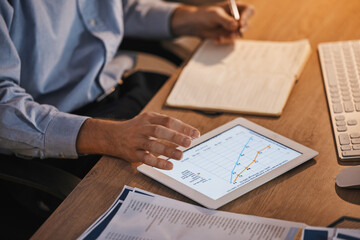 Chart, writing and tablet with hands of businessman for planning, data analytics and profit growth....
