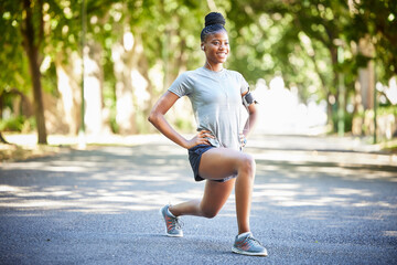 Black woman, fitness and stretching legs in preparation for running, cardio exercise or workout in nature. African American female in warm up leg lunges getting ready for exercising, run or training - Powered by Adobe