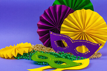 Festive Mardi Gras masquerade violet background. Fat Tuesday carnival, masks, beads, traditional...