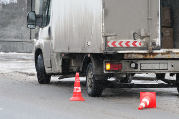 Car marked with cones on the road, unloading